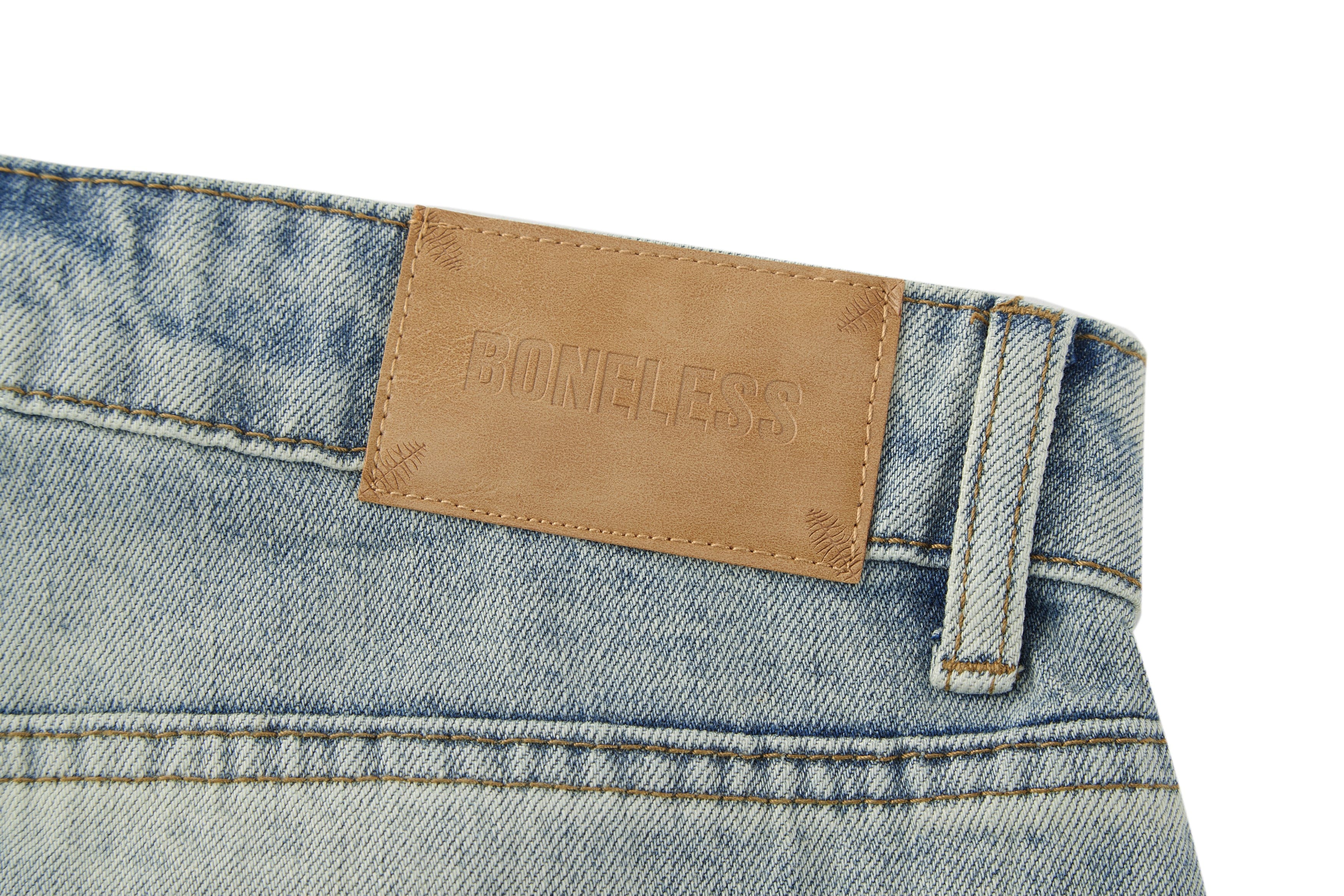 BONELESS Washed Ripped Hem Curved Baggy Jeans