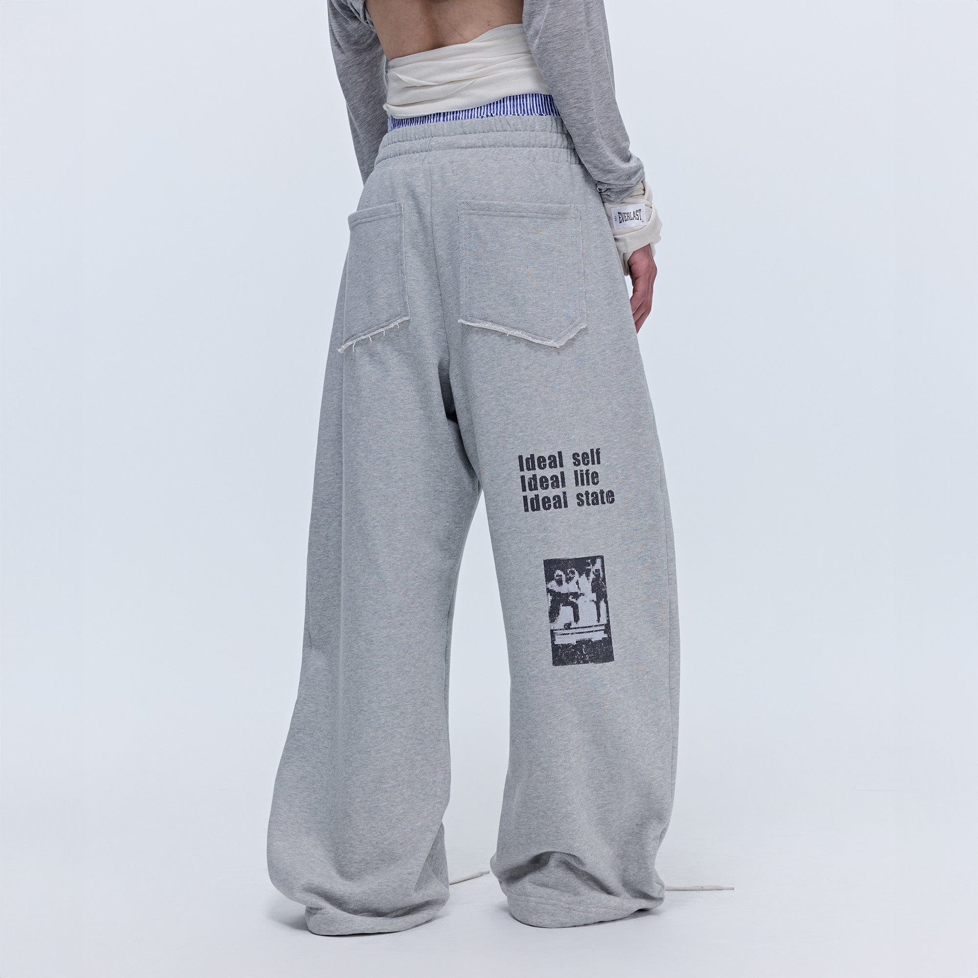 SAVAGEGROWTHWORLD Slogan Curved Drawstring Sweatpants, premium urban and streetwear designers apparel on PROJECTISR.com, SAVAGEGROWTHWORLD