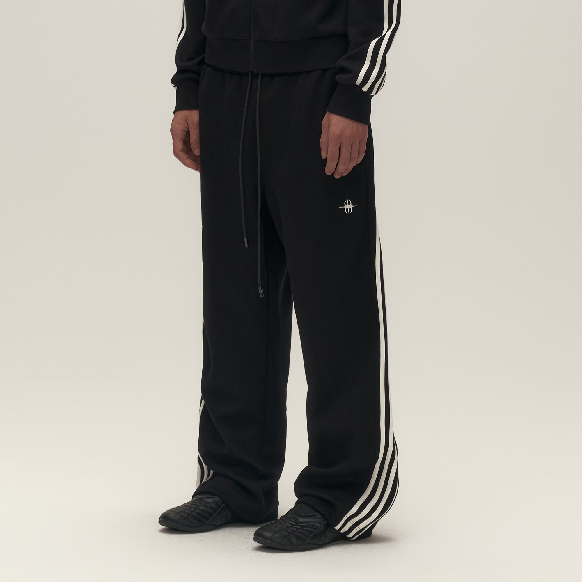 SAVAGEGROWTHWORLD Back-Arc Striped Graphic Track Pants, premium urban and streetwear designers apparel on PROJECTISR.com, SAVAGEGROWTHWORLD