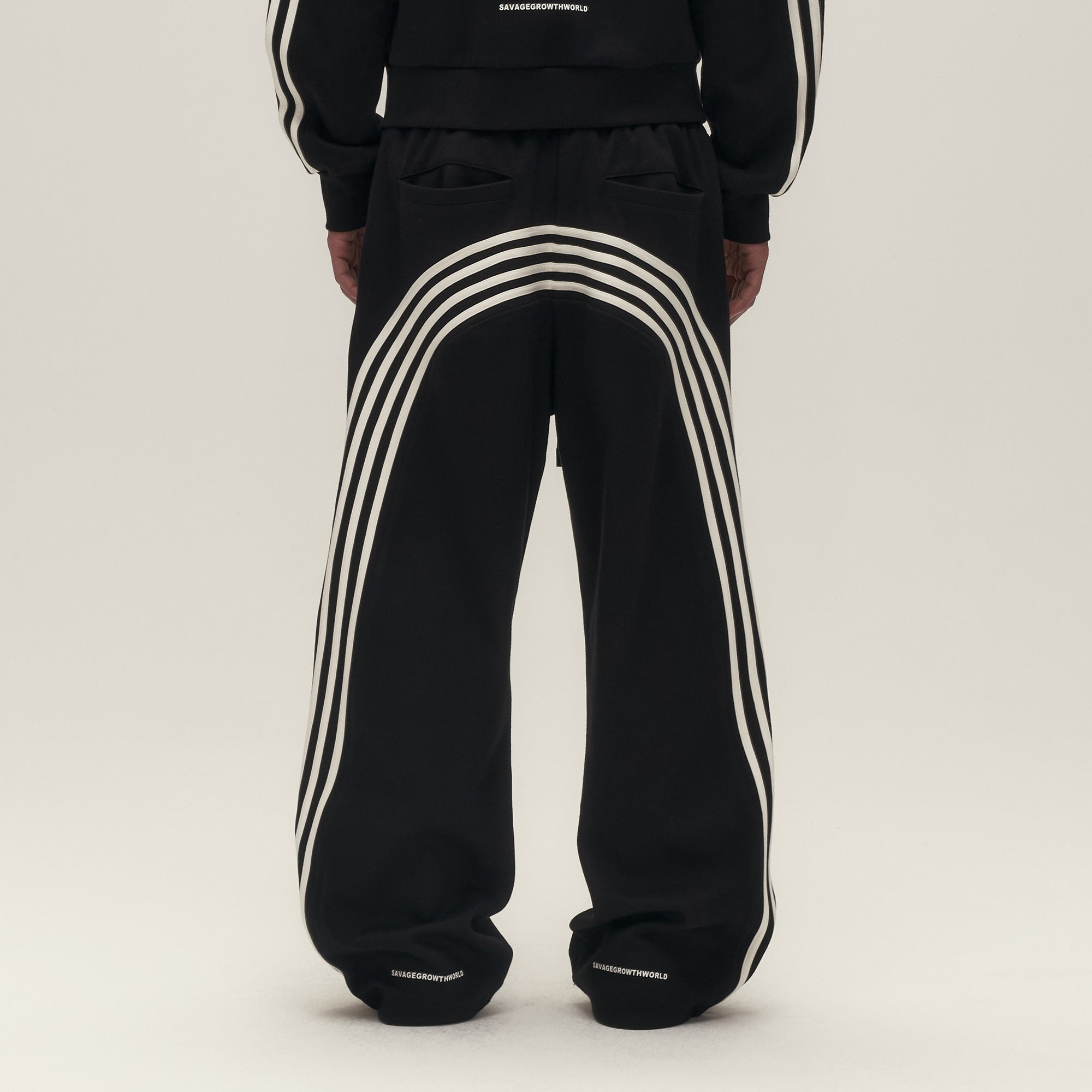 SAVAGEGROWTHWORLD Back-Arc Striped Graphic Track Pants, premium urban and streetwear designers apparel on PROJECTISR.com, SAVAGEGROWTHWORLD