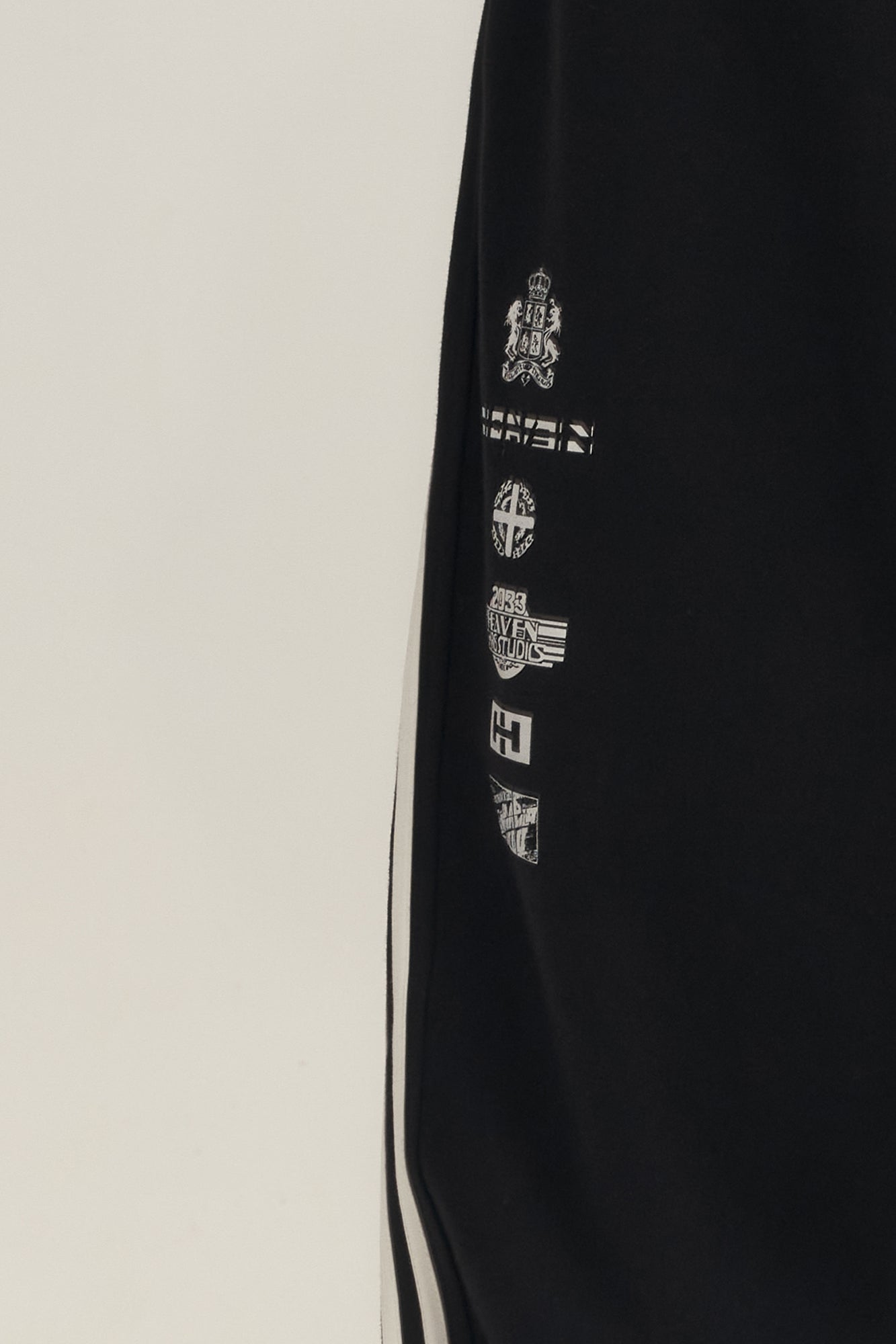 SAVAGEGROWTHWORLD Back-Arc Striped Graphic Track Pants, premium urban and streetwear designers apparel on PROJECTISR.com, SAVAGEGROWTHWORLD