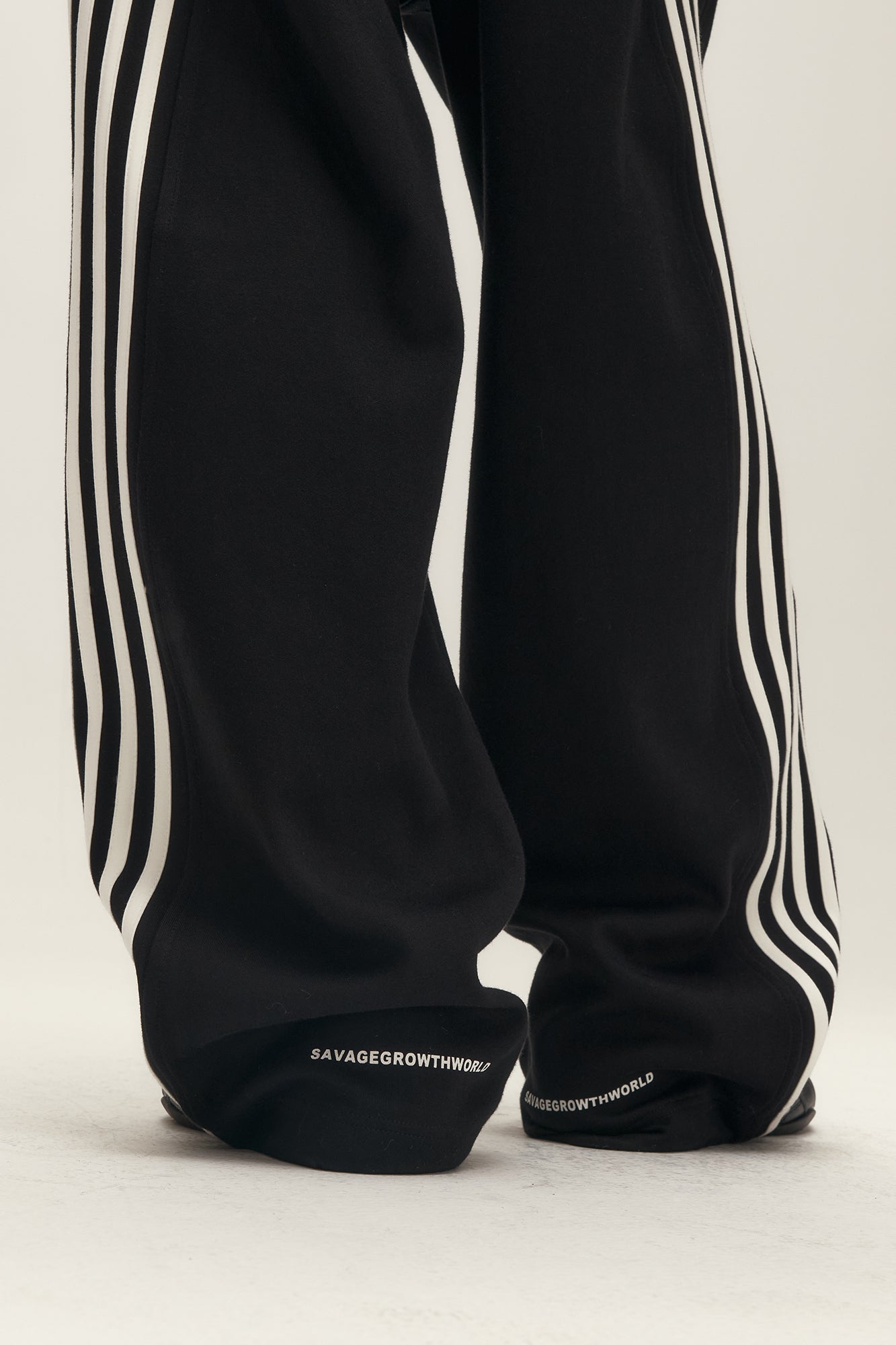 SAVAGEGROWTHWORLD Back-Arc Striped Graphic Track Pants, premium urban and streetwear designers apparel on PROJECTISR.com, SAVAGEGROWTHWORLD