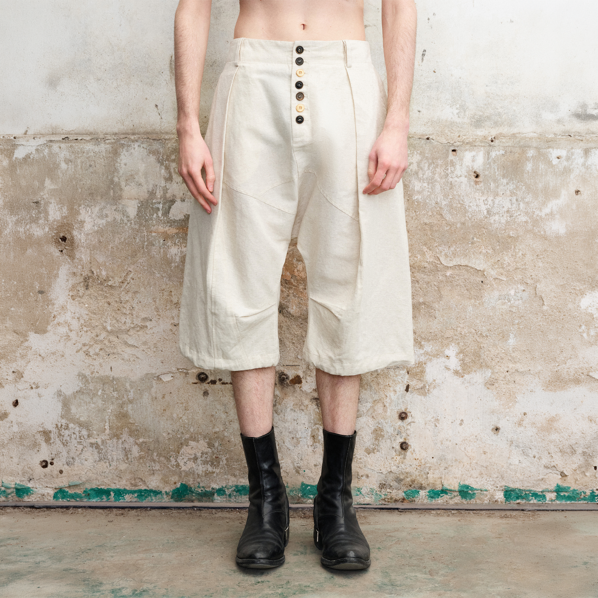 ILNya Nieternite Nifutur Pleated Drop-Crotch Button-Fly Cropped Pants White, premium urban and streetwear designers apparel on PROJECTISR.com, ILNya Nieternite Nifutur