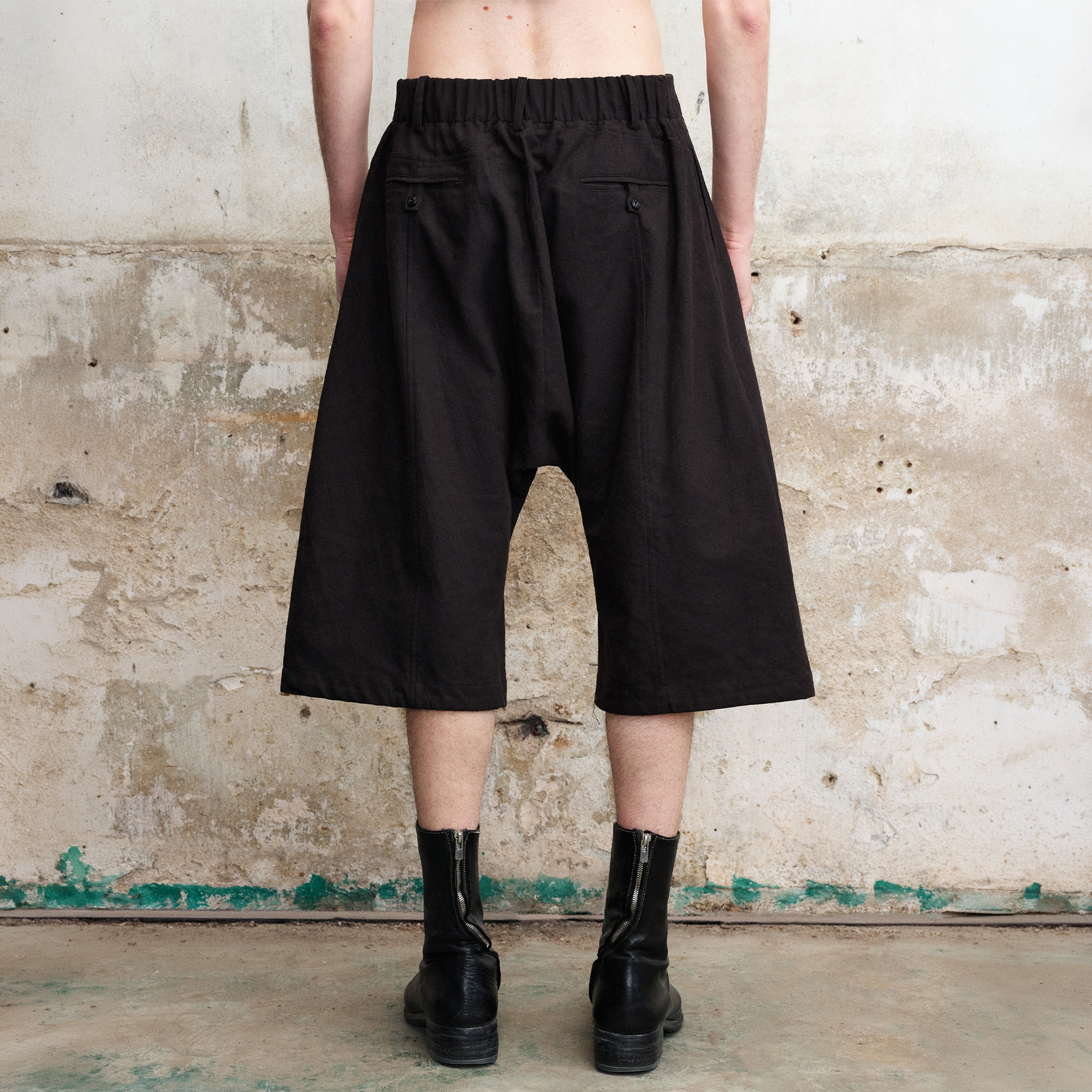 ILNya Nieternite Nifutur Pleated Drop-Crotch Button-Fly Cropped Pants Black, premium urban and streetwear designers apparel on PROJECTISR.com, ILNya Nieternite Nifutur