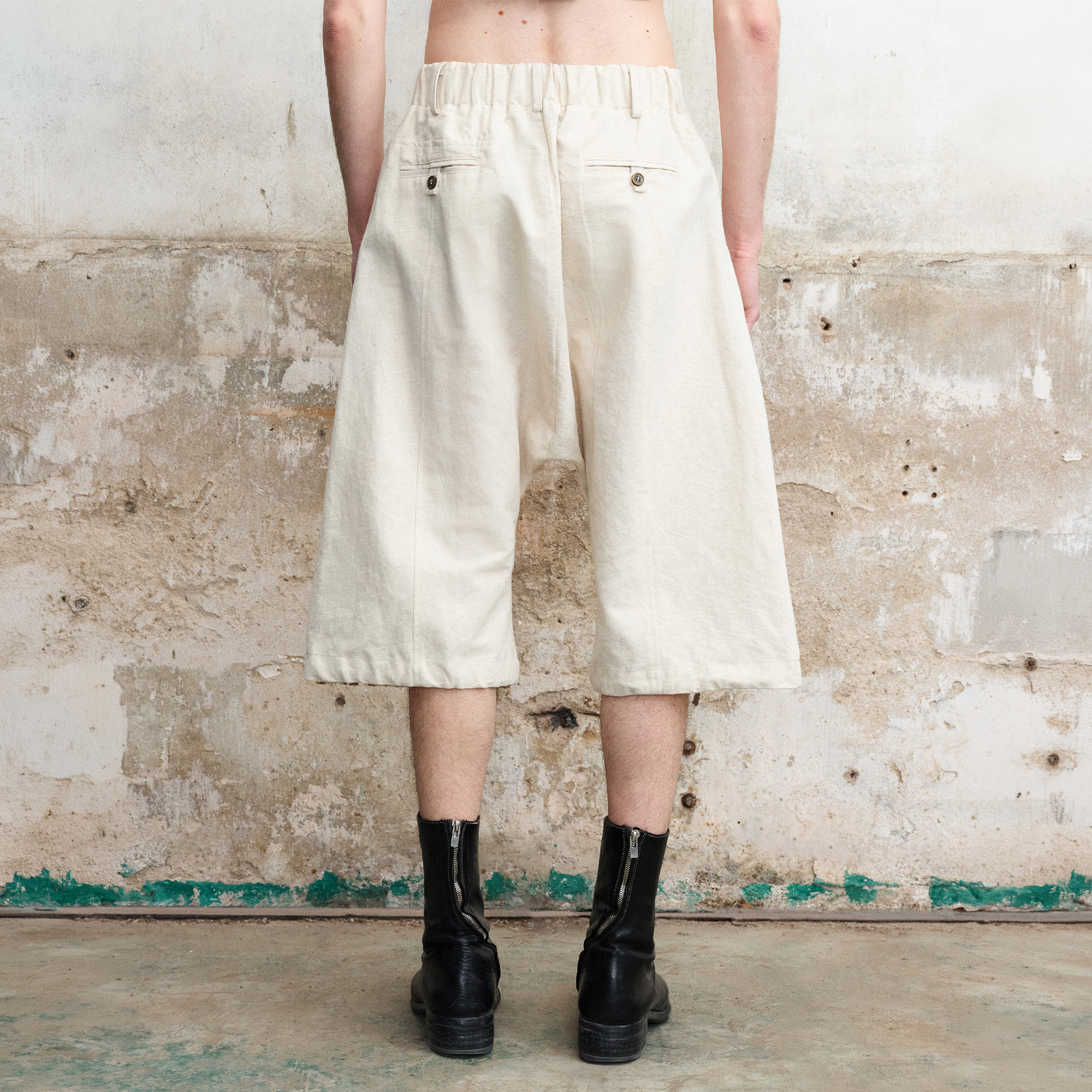 ILNya Nieternite Nifutur Pleated Drop-Crotch Button-Fly Cropped Pants White, premium urban and streetwear designers apparel on PROJECTISR.com, ILNya Nieternite Nifutur