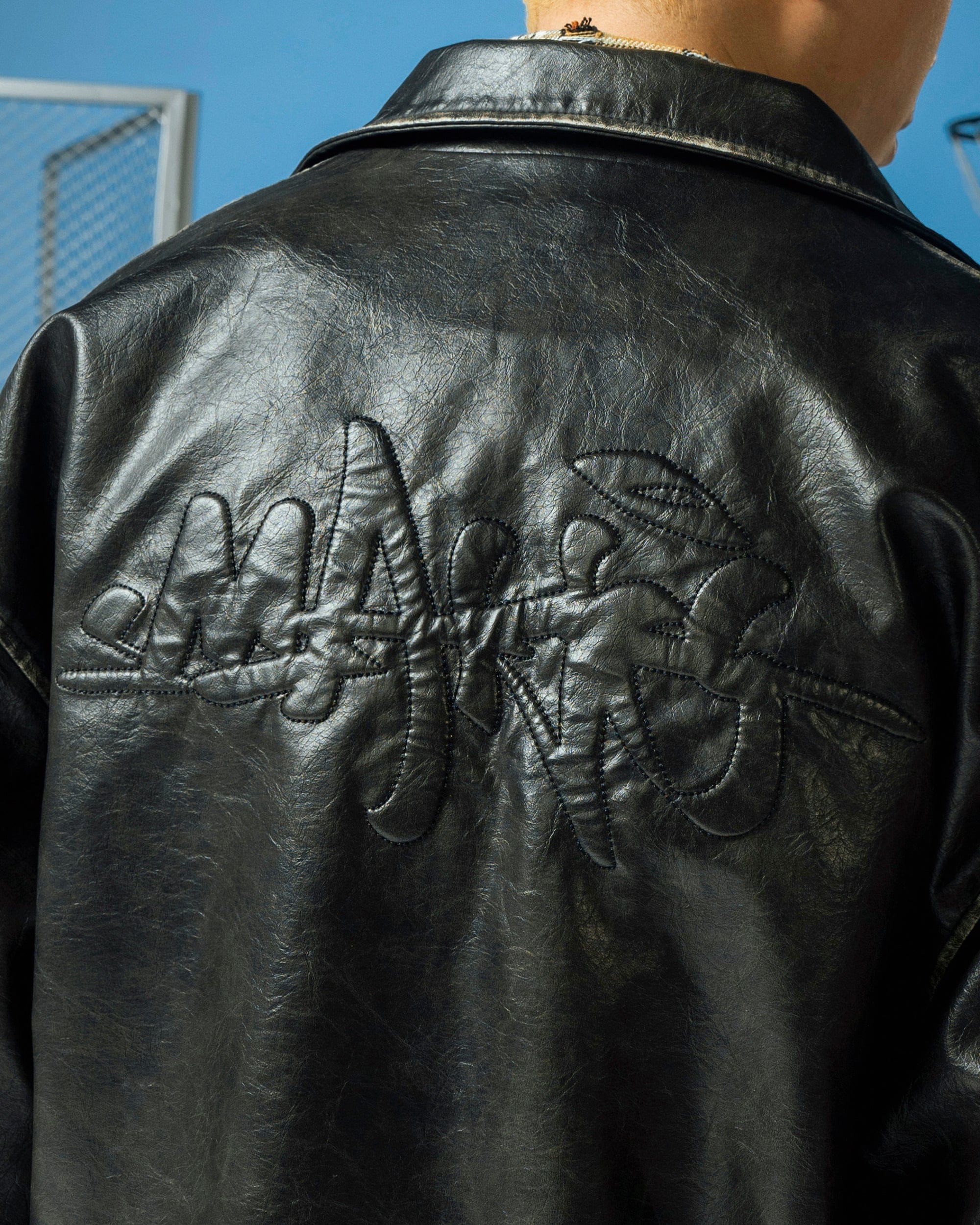 MAKEMORE Classic Faux Leather Embossed Coach Jacket